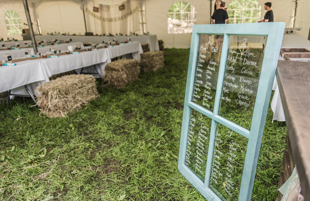 Country style seating plan for reception dinner on window panes. - Photo, Image