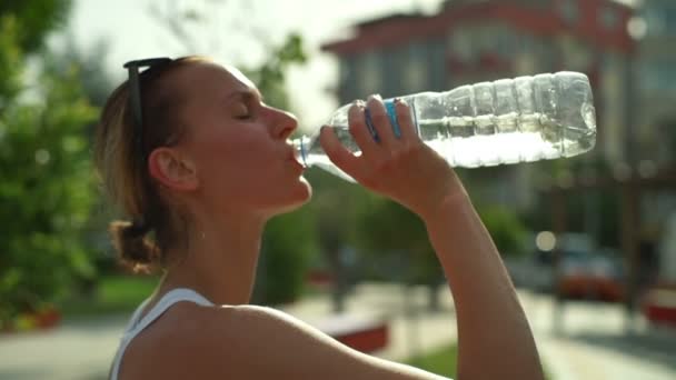 exhausted after work out women drinks water greedily - Filmmaterial, Video