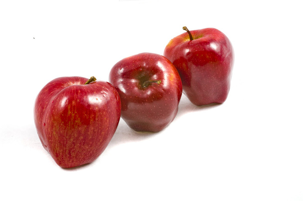 eating autumn red apple on white background - Photo, Image