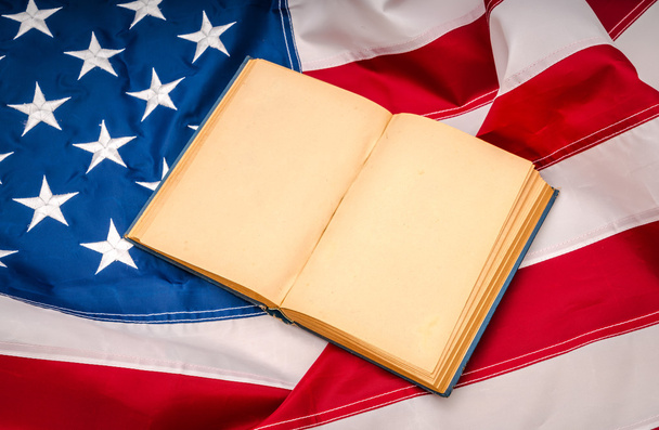 Vintage open book on American flag - Фото, зображення