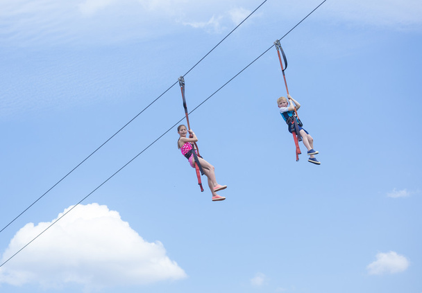 kids playing on a zip  - Photo, Image