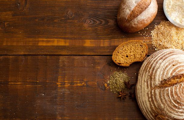 Brown bread on the wooden table - Φωτογραφία, εικόνα