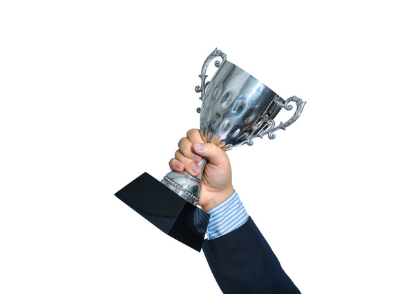 Businessman holding a champion silver trophy on white background - Photo, Image