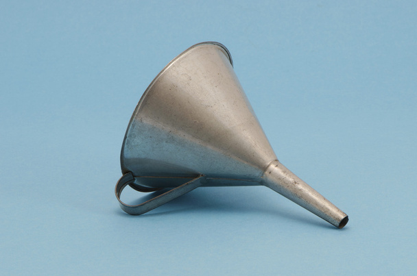 Ancient metal aluminum funnel on blue background - Photo, Image