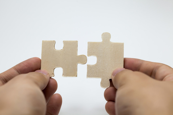 Human hands connecting pieces of jigsaw - Business team, solving problem together concept - Photo, Image