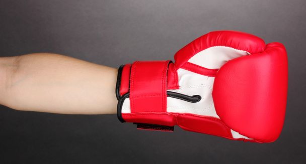 Red boxing gloves on hands on grey background - Zdjęcie, obraz