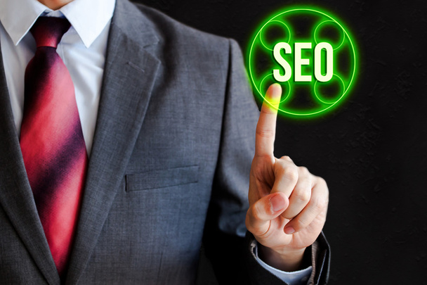 Businessman pressing SEO icon in the air with one finger - search engine optimization, internet business concept - Photo, Image