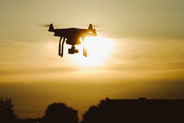 Flying drone at sunset - Photo, Image