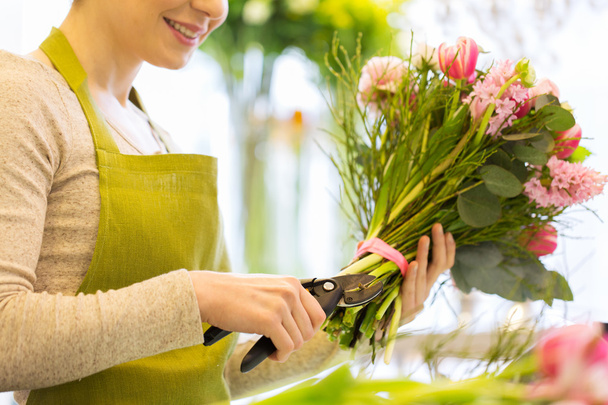 close up of florist woman with flowers and pruner - Valokuva, kuva