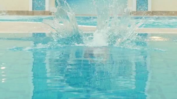 beautiful girl jumping into the pool - Materiał filmowy, wideo