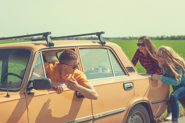 Young hipster friends on road trip on a car - Фото, зображення