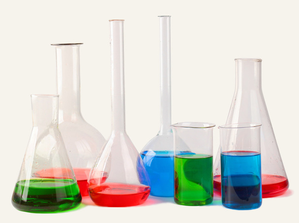 Chemical glassware with colorful liquids isolated on white backg - Fotografie, Obrázek