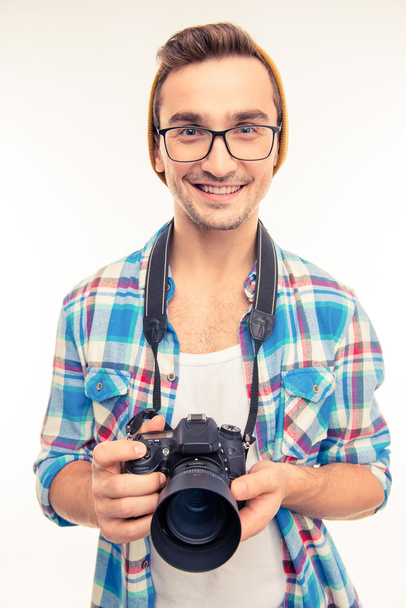 Young handsome photographer taking a photo - Фото, изображение