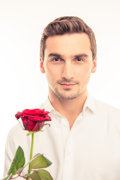 Romantic handsome man with a red rose - Fotó, kép