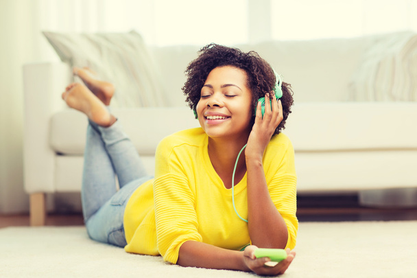 happy african woman with smartphone and headphones - Photo, Image