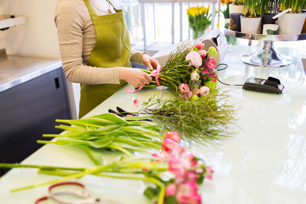 close up of woman making bunch at flower shop - Фото, изображение