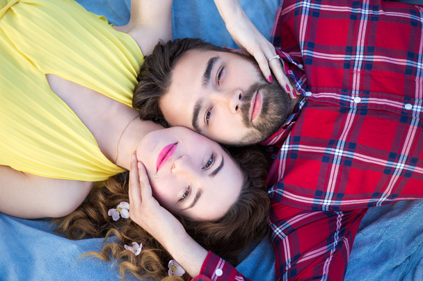 top view of young beautiful couple lying on blanket - Φωτογραφία, εικόνα