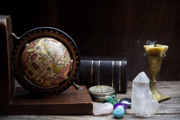 Ancient astrology. Old astrology globe and books with candle - Fotoğraf, Görsel