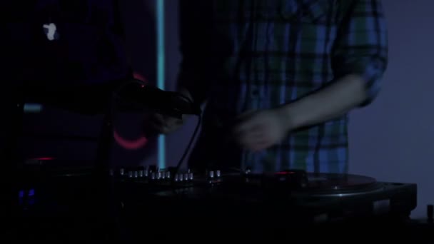 DJ bakelitlemezek karcolás és a keverés a fedélzeten egy disco, szórakozóhely - Felvétel, videó