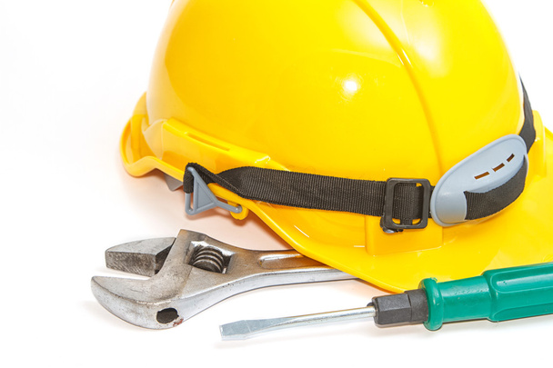 Helmet with construction tools on white background - Photo, Image