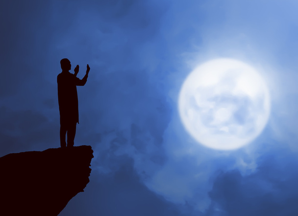  silhouet man bidden - Foto, afbeelding