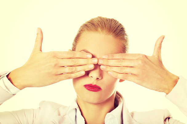 Business woman covering her eyes with her hands. See no evil concept - Фото, зображення