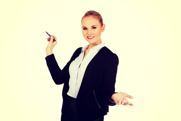 Young business woman pointing for copyspace or board - Фото, зображення