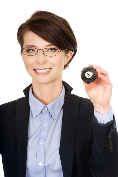 Businesswoman holding eight billiard ball. - Фото, изображение