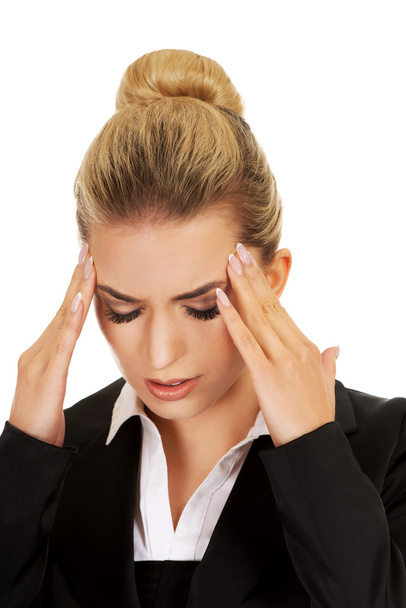 Young businesswoman having huge headache - Foto, Imagen