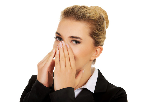 Businesswoman giggles covering her mouth with hand - Foto, Bild
