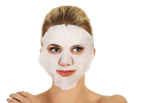 Young happy woman with facial mask. - Foto, Imagen