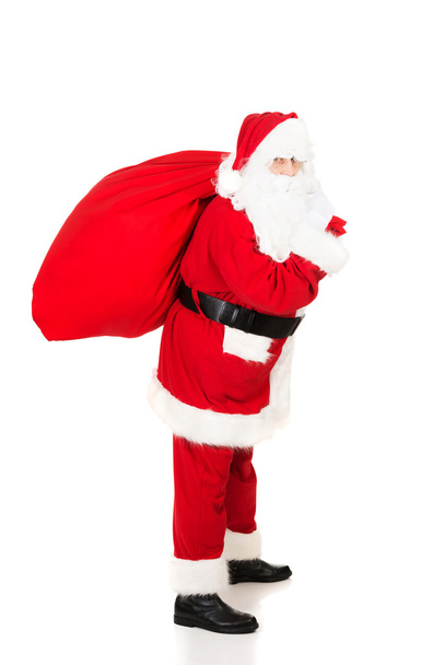 Santa Claus carrying bag with presents - Φωτογραφία, εικόνα