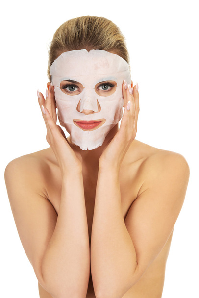 Young happy woman with facial mask. - Photo, image
