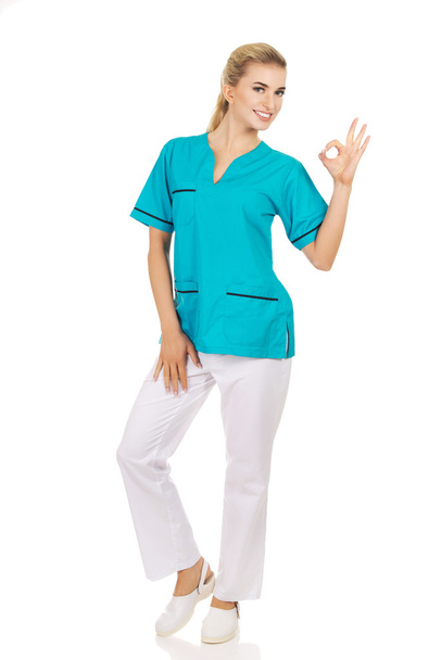 Young female doctor or nurse gesturing perfect - Foto, imagen