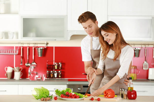 Couple in aprons cooking - Фото, зображення