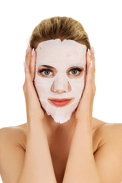Young woman with facial mask - Zdjęcie, obraz