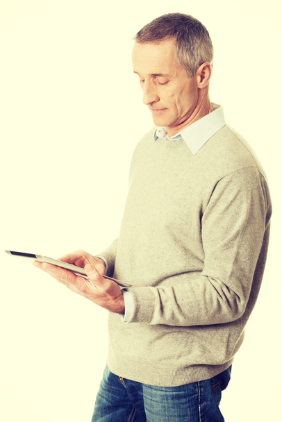 Mature man using digital tablet - 写真・画像