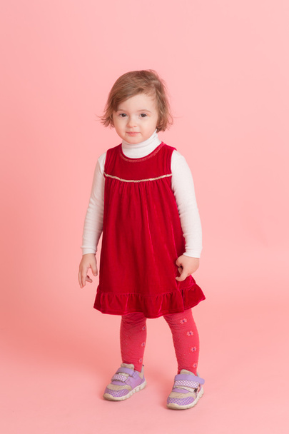 little girl in a red dress - Фото, изображение