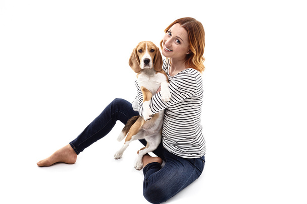 Cute young woman is embracing her dog - Photo, image
