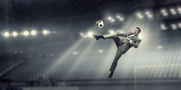 Businessman kicking ball - Zdjęcie, obraz