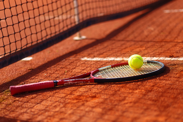 Tennis ball and racket on the court. - Фото, зображення