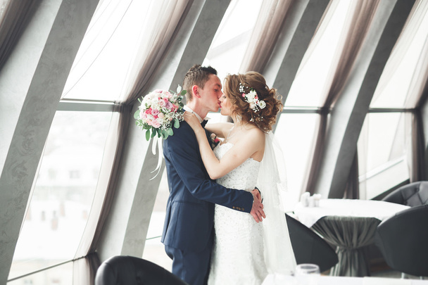wedding couple is standing and kissing in hotel - Foto, immagini