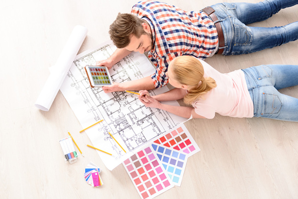 Young couple choosing colors of their new flat - Photo, Image
