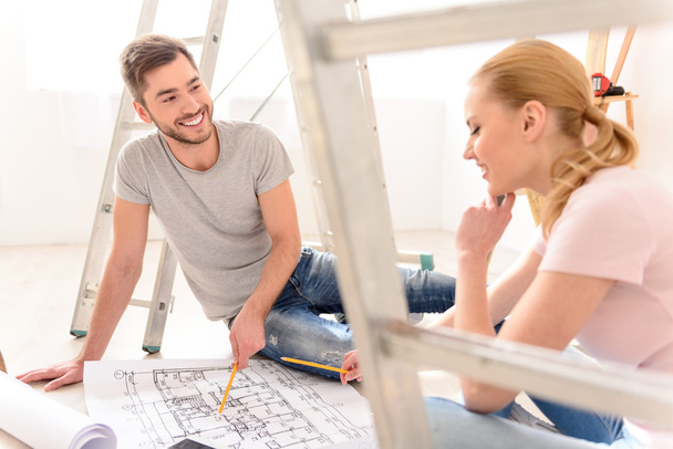 Young couple discussing apartments plan - 写真・画像