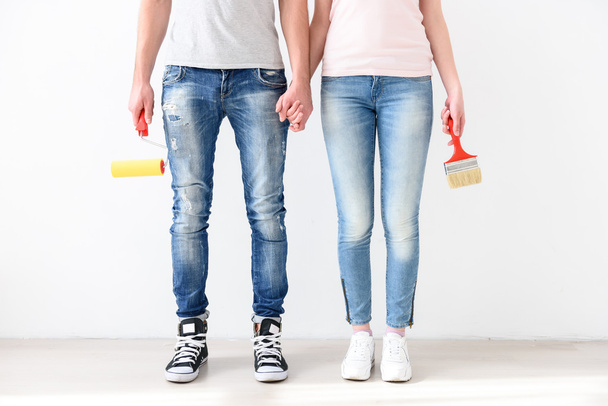 Guy and girl standing with brushes - Φωτογραφία, εικόνα