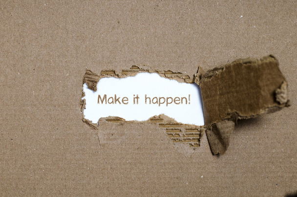 The word make it happen appearing behind torn paper. - Photo, Image
