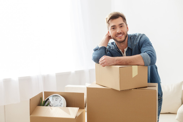 Smiling guy moving into his new home - Photo, image