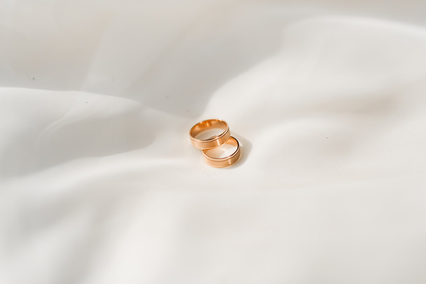 luxury wedding rings lying on the leaves and grass - Photo, Image