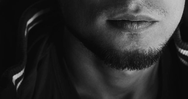 Black and white portrait. Close up of a man's lips - Фото, изображение