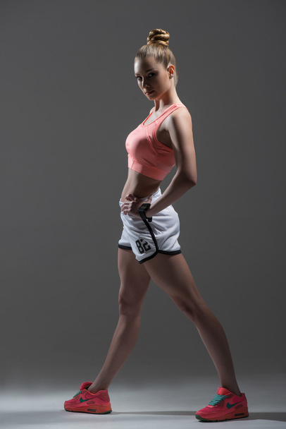 Beautiful sporty girl showing her perfect figure - 写真・画像